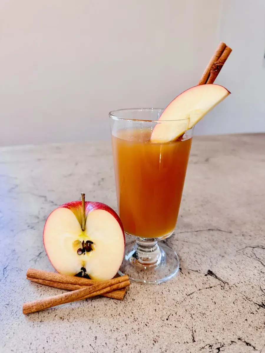 Apple cider cocktail with cinnamon garnish