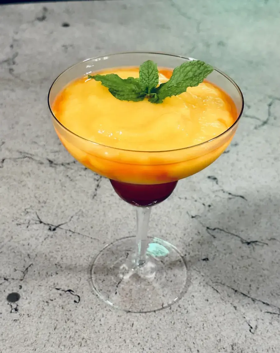 Mango cocktail with mint garnish